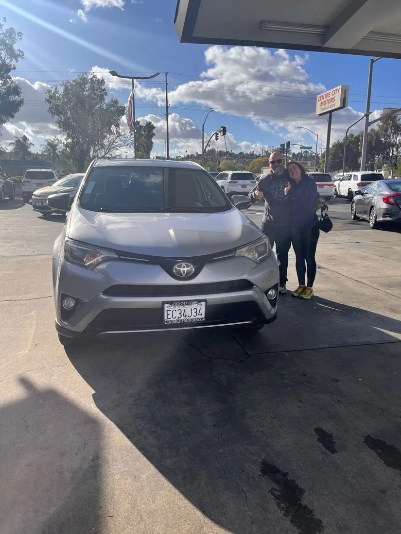 Grant and his wife with their Toyota RAV4