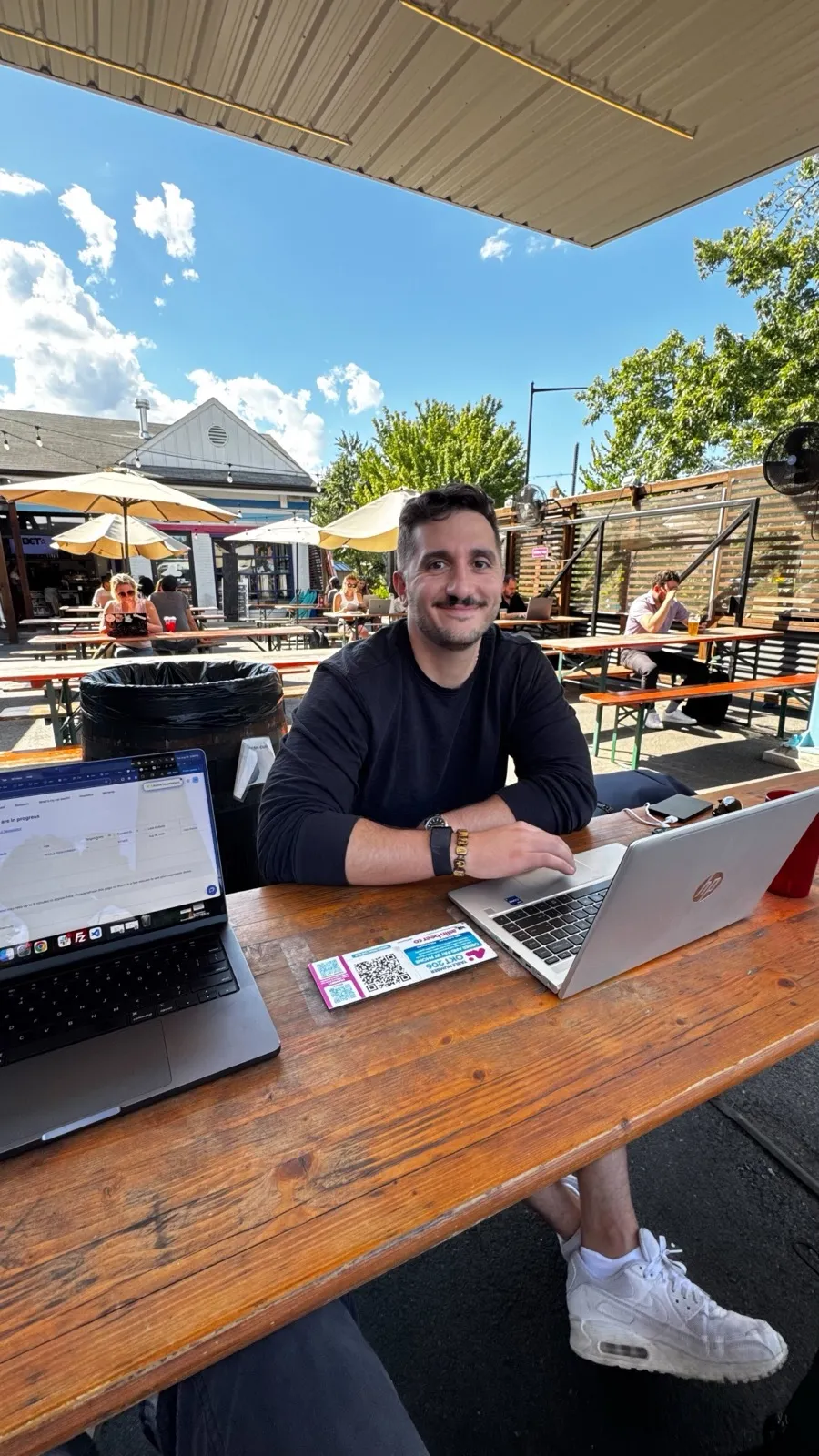 A CarEdge teammate working remotely from a sunny patio